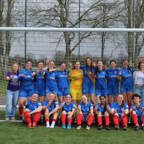 Women's Football team grouped together for a photo after a match