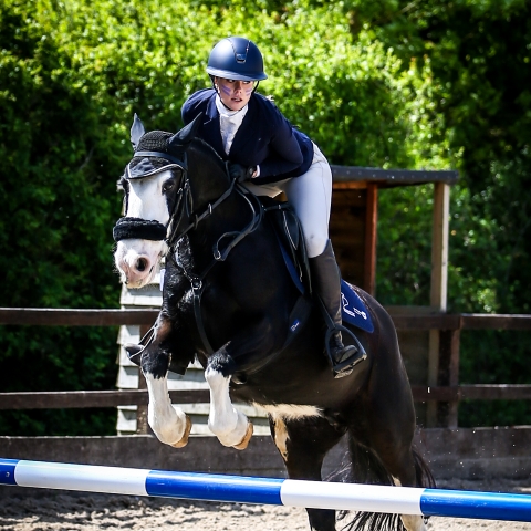 Student on a horse competing in jumping