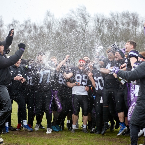 American Football club members celebrating promotion