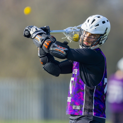 Lacrosse player wearing UOP playing kit warming up for a match