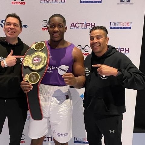 Derrick Osadolor holding National Champion belt
