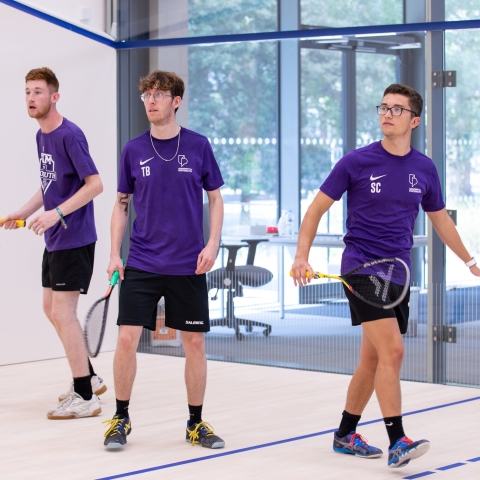 Photo of three students using the squash court - Ravelin Activities