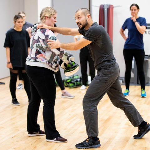 Self defence instructor leading a class in a studio