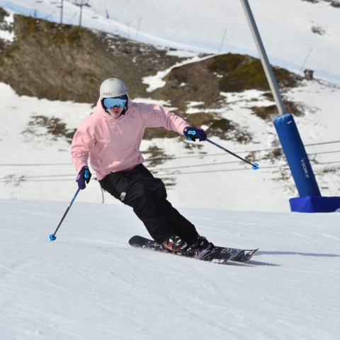 A University of Portsmouth athlete skiing down a mountain