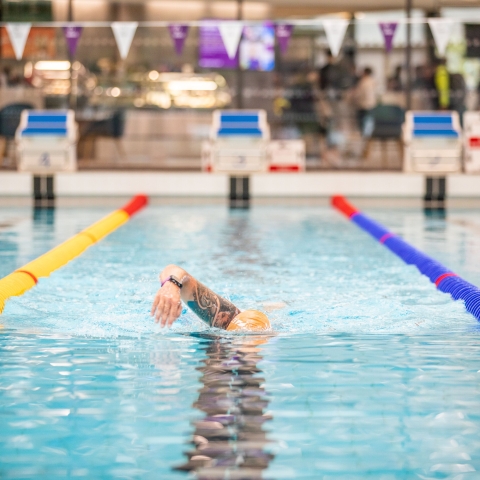 Front photo of man swimming in poolRavelin Interior