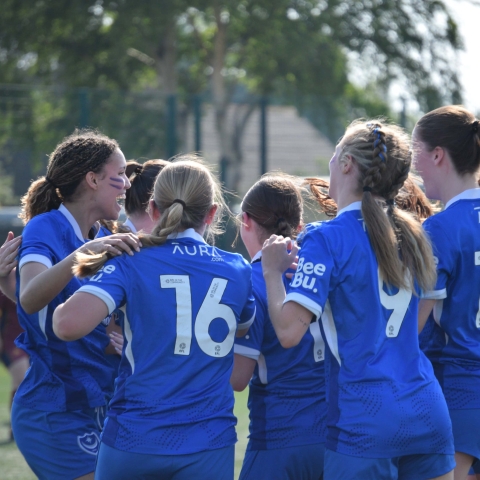 Women's football team celebrating together