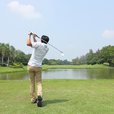 Golfer swinging for ball
