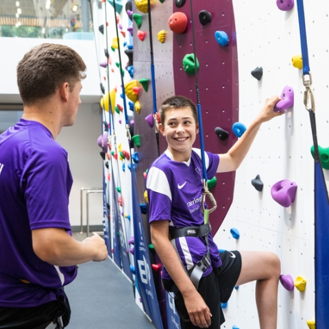 Instructor teaches child who to scale the bouldering wall at Ravelin Sport Centre.Ravelin Sports Event - Children