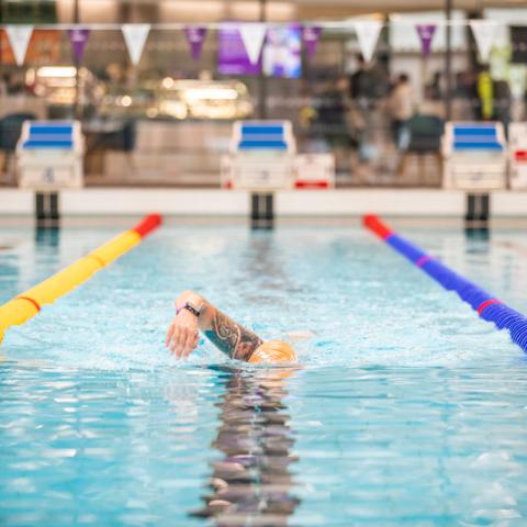 Front photo of man swimming in poolRavelin Interior
