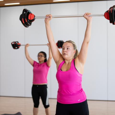 Photo of two women in weight lifting aerobics class - Ravelin Activities