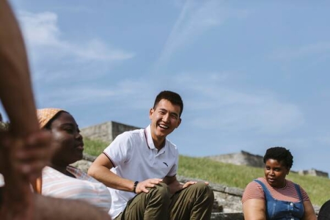 students smiling and socialising on steps