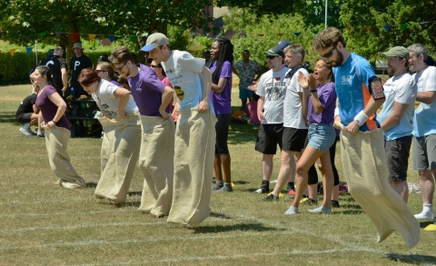 Staff racing in hessian sacks during Staff Sports Day
