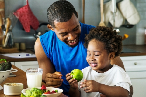 Parent and child eating fruit