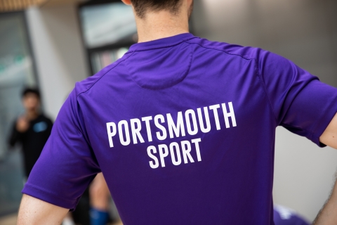 Photo of back of staff's shirt with Portsmouth Sport text - Ravelin Activities