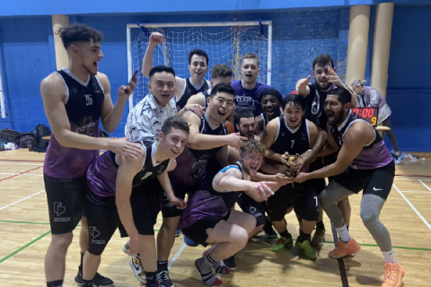 Students holding intramural varsity trophy