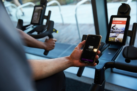 Person holding a phone with technogym app