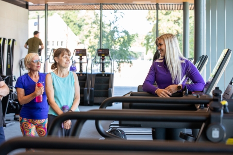 Women receiving induction on how to use fitness suite machines - Ravelin Activities