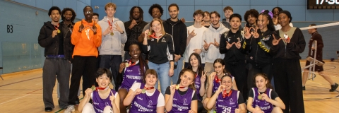 Basketball women's team celebrating winning conference cup 2026