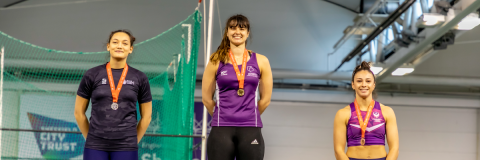 Serena Vincent with gold medal on a podium