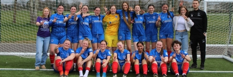 Women's Football team grouped together for a photo after a match