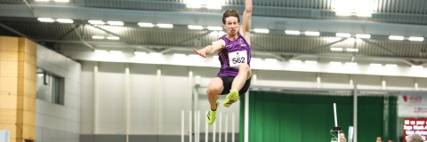 student competing in long jump
