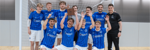Futsal team celebrating at Students vs Alumni Cup 2025