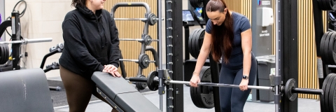 Two females exercising in the gym