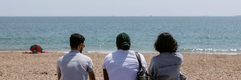 Students sat on southsea beach staring out to see