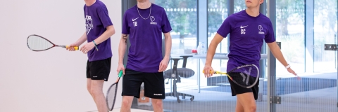 Photo of three students using the squash court - Ravelin Activities