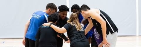 Photo of Volleyball team in huddle at multi sport court - Ravelin Activities