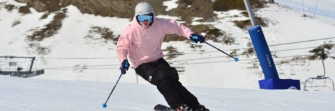 A University of Portsmouth athlete skiing down a mountain