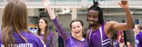 Students in trampolining competition kit celebrating