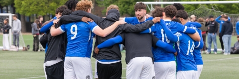 Men's Football team huddle