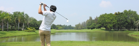 Golfer about to hit ball