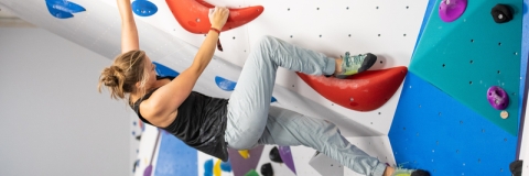 Photo of female visitor using Climbing and Bouldering wall - Ravelin Activities