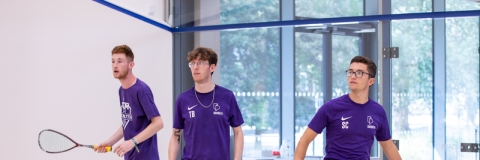 Photo of three students using the squash court - Ravelin Activities