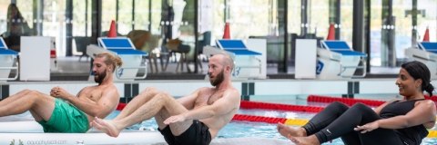 Public enjoying water aerobics class at swimming pool - Ravelin Activities