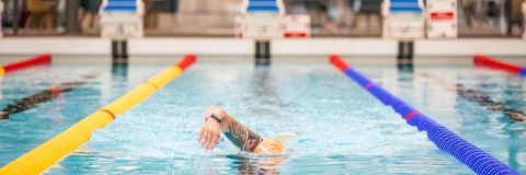 Front photo of man swimming in poolRavelin Interior