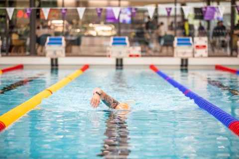 Front photo of man swimming in poolRavelin Interior