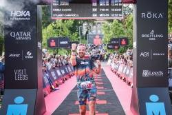 Ben Jarvis crossing the finish line at Ironman Leeds