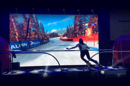 Ski simulator used by skier in front of virtual slope
