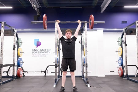 Miles performing olympic lifting