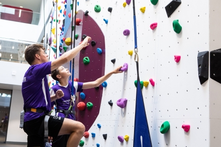 Instructor teaches child who to scale the bouldering wall at Ravelin Sport Centre.Ravelin Sports Event - Children