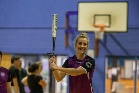 student swinging for the ball