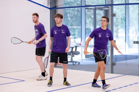 Photo of three students using the squash court - Ravelin Activities