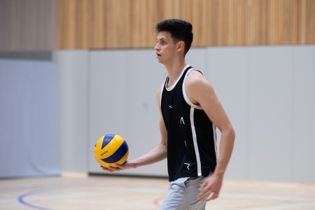 Photo of male student holding volleyball - Ravelin Activities