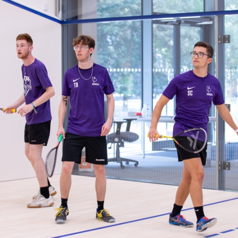 Photo of three students using the squash court - Ravelin Activities