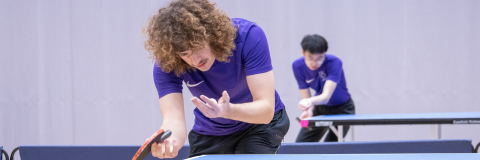 Two table tennis players about to serve